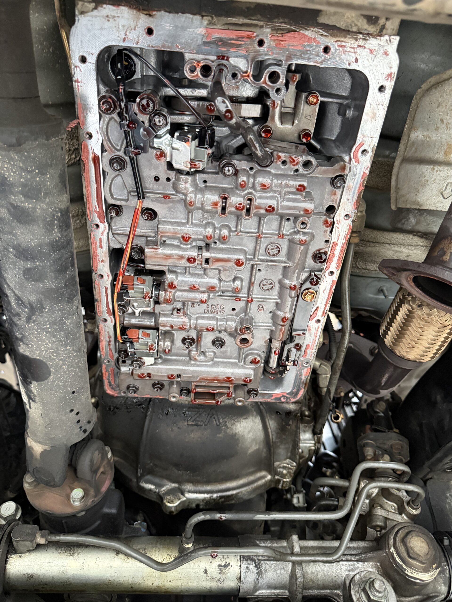 Exposed transmission valve body photographed in the Luca Motors workshop in Alphington.