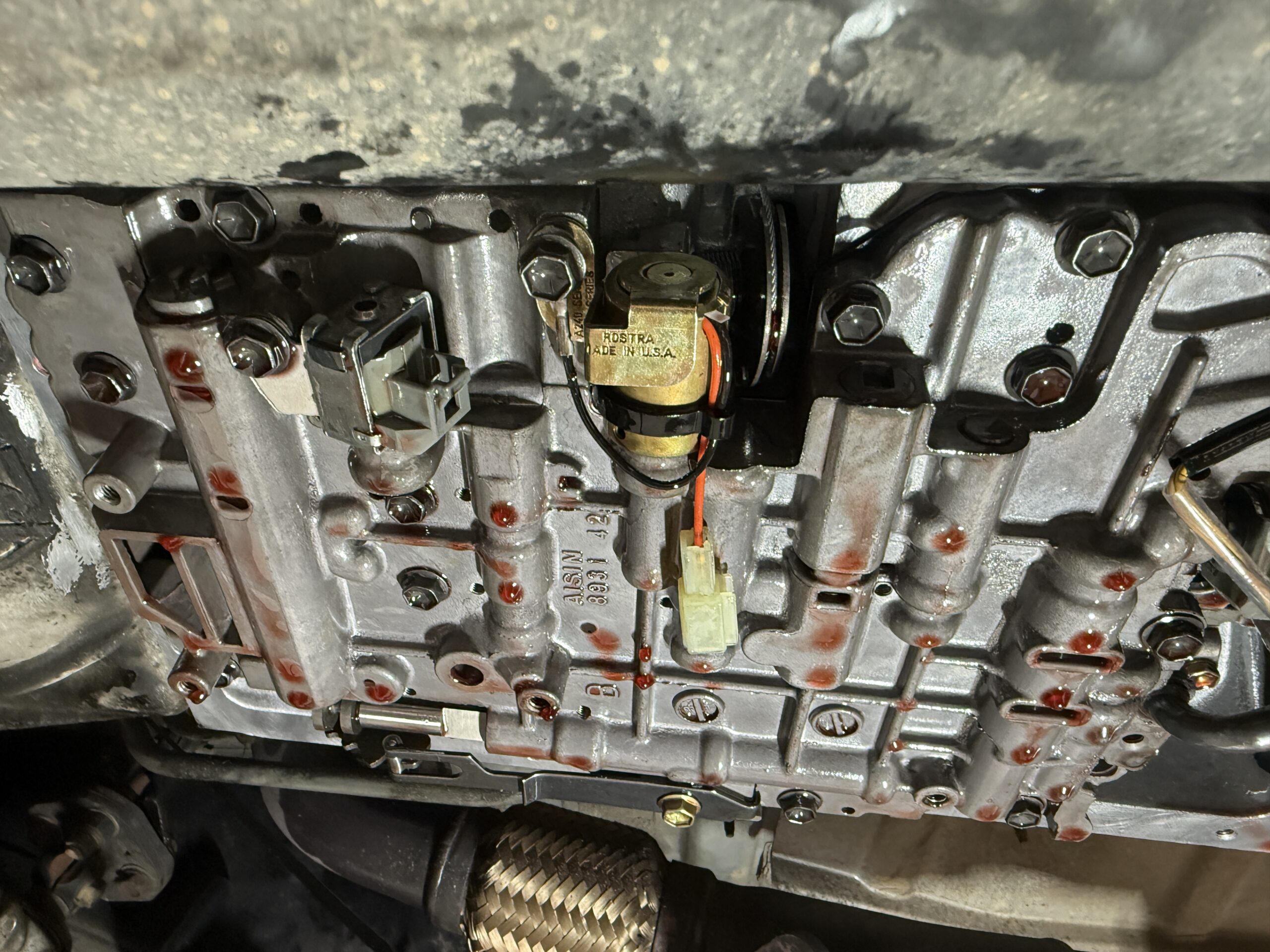 Close-up of a mounted component within an exposed transmission assembly.